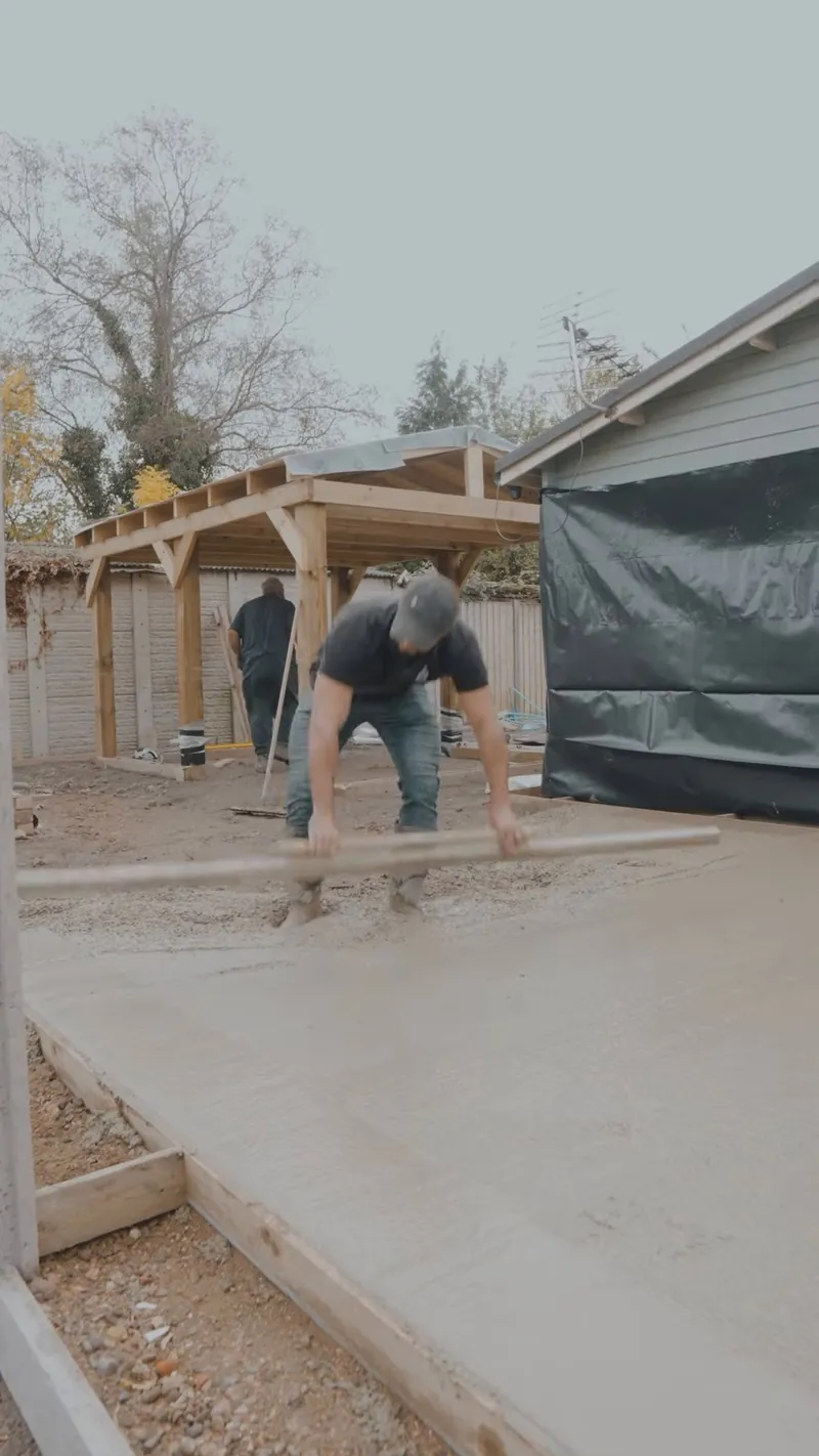 Concrete being laid and levelled under the pergola in Wisbech