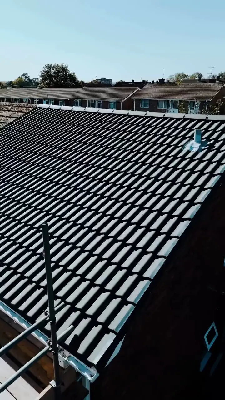 Rows of new dark grey double pantiles on the roof in Ramsey