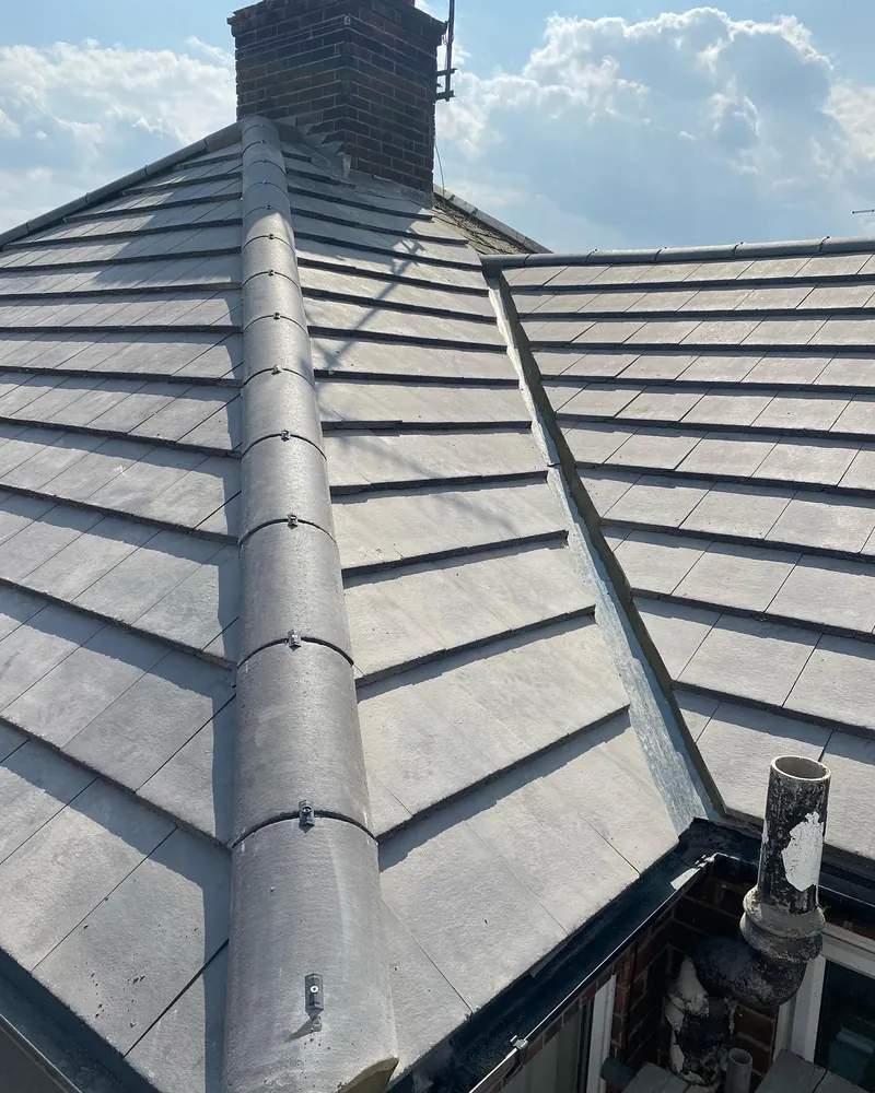 Dry ridge and hip detail on a new flat concrete tile roof in Peterborough