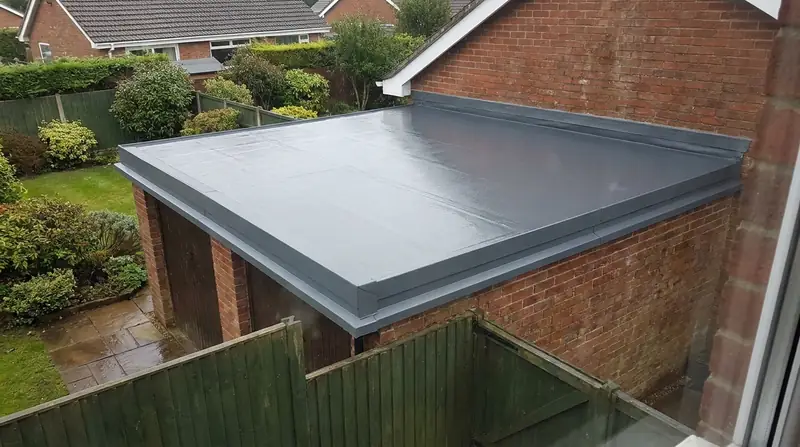 Grey EPDM rubber flat roof on a UK brick garage