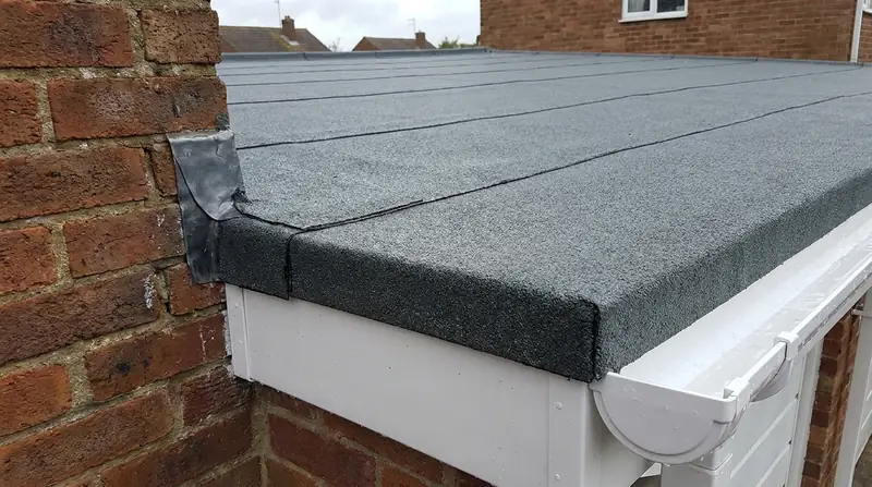 Torch-on felt flat roof detail with lead flashing and new guttering