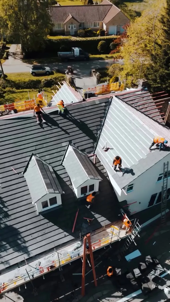Crest Planum tiles going on around the dormers in Stamford