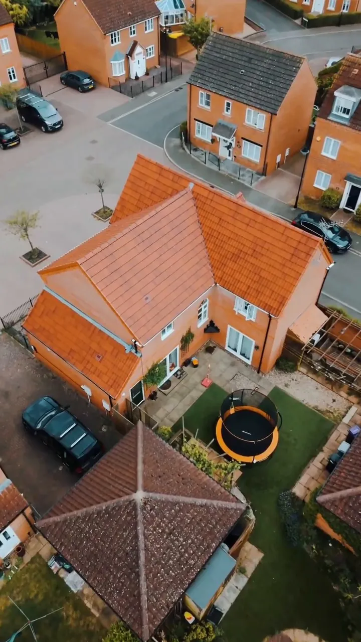 Completed red tile re-roof among new-build homes in Peterborough