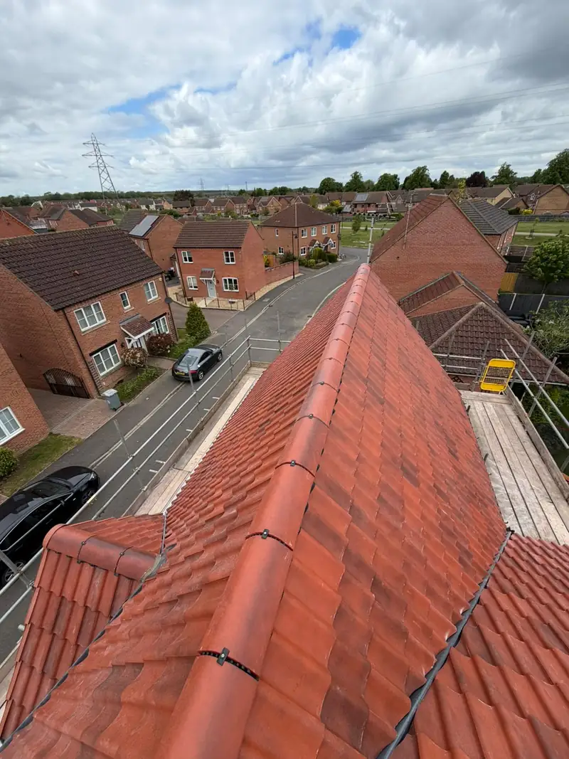 New ridge line with mechanically fixed dry ridge on the Bourne re-roof, looking out over the estate