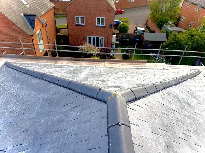 Dry-fix ridge junction on the new slate roof in Hallaton