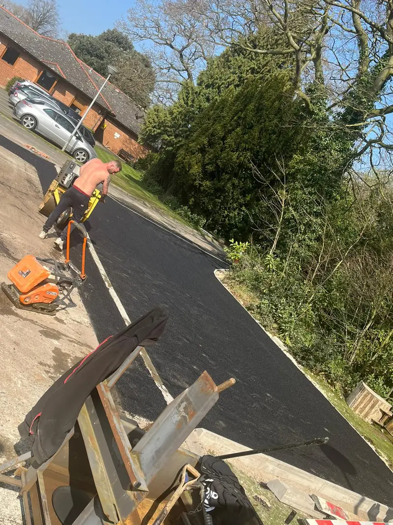 Fresh tarmac being laid on a UK driveway by the Arkenstone team